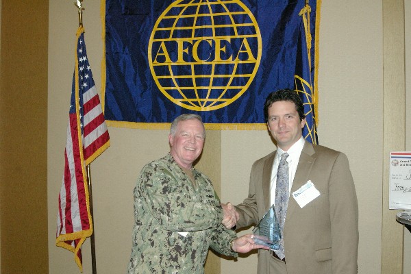 Capt. Slevin congratulates Mark Christensen, first vice president, in April for his overall dedication to the chapter.